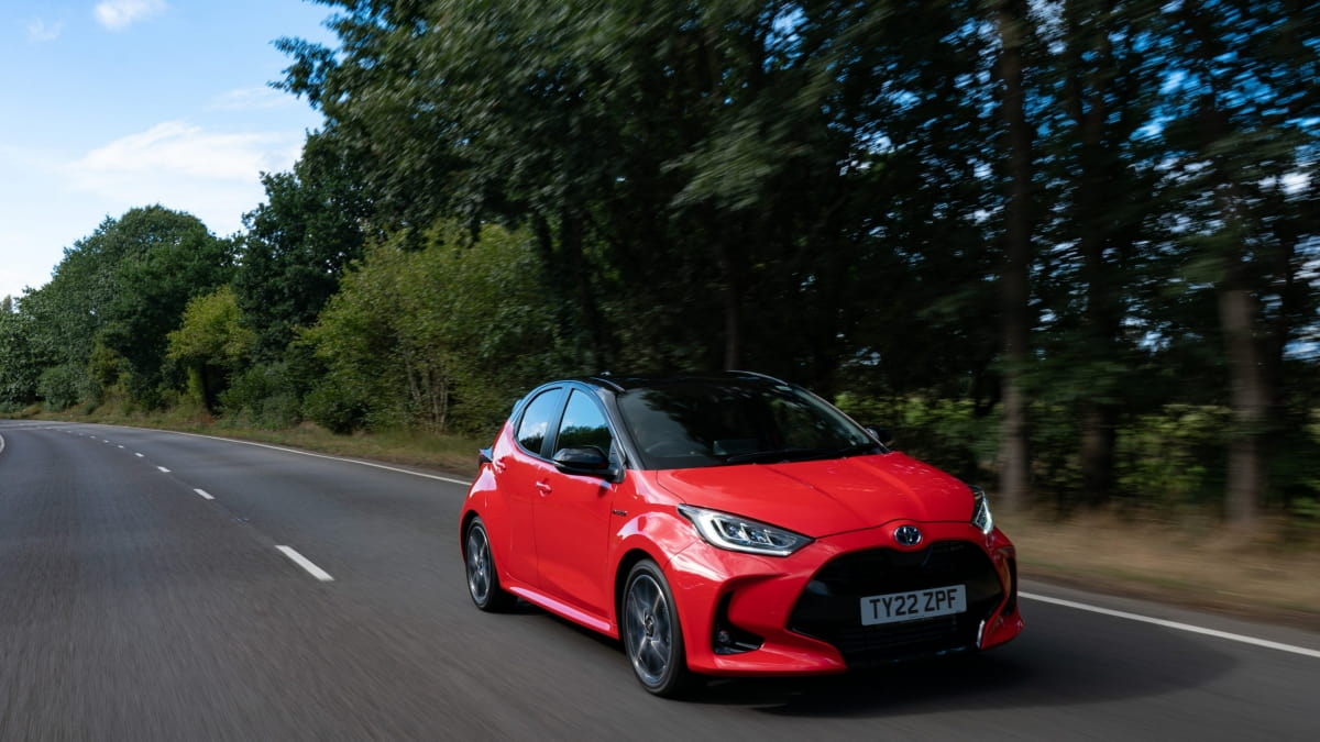 red 2025 Toyota Yaris Hybrid driving