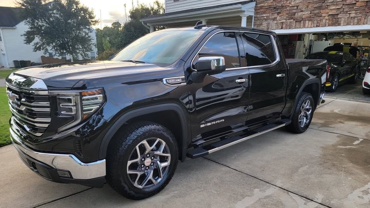2025 GMC Sierra 1500 SLT in a driveway in North Carolina side view