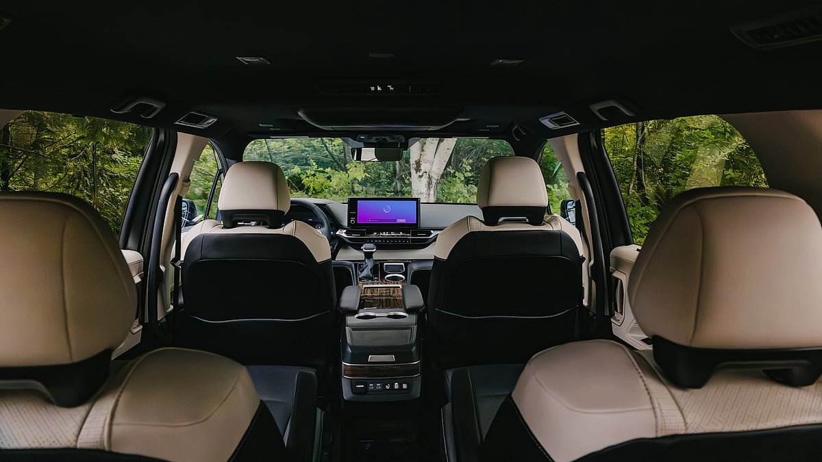 2025 Toyota Sienna Platinum interior showing three rows of seats and the dashboard screen.