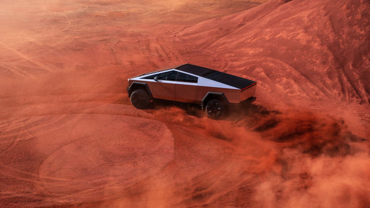 Tesla Cybertruck driving through red desert terrain, kicking up dust and highlighting off-road electric truck capability.