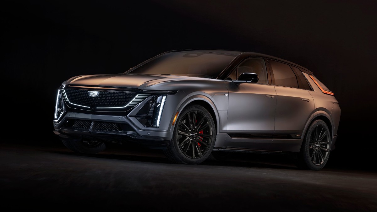 Metallic gray 2026 Cadillac Lyriq SUV with black wheels, angled dynamically against dark background