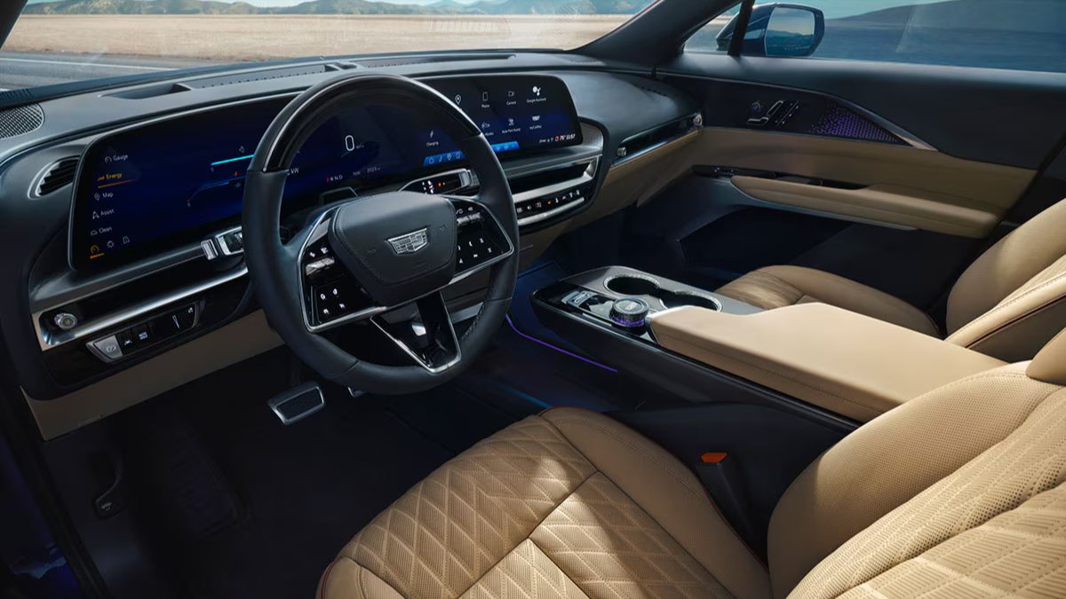 Luxurious 2026 Cadillac Lyriq interior with tan leather seats, digital dashboard, and ambient blue lighting