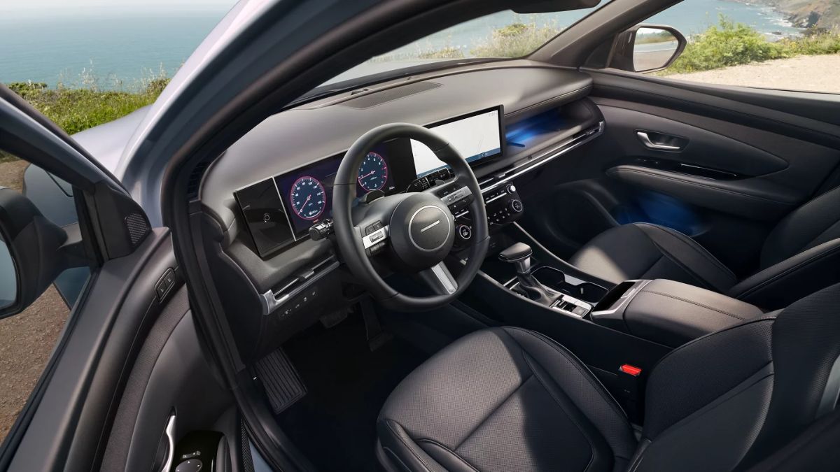 A 2026 Hyundai Santa Cruz interior with a sleek design features a digital dashboard. View of the ocean and sky through the windshield adds a serene backdrop.
