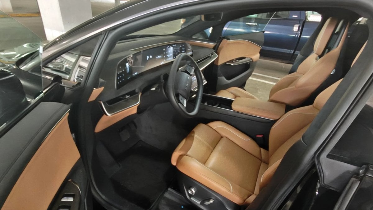 Luxurious 2026 Lucid Gravity interior with caramel leather seats, digital dashboard, and sleek black trim