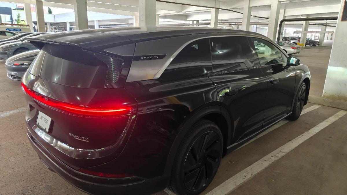 Luxurious 2026 Lucid Gravity interior with caramel leather seats, digital dashboard, and sleek black trim