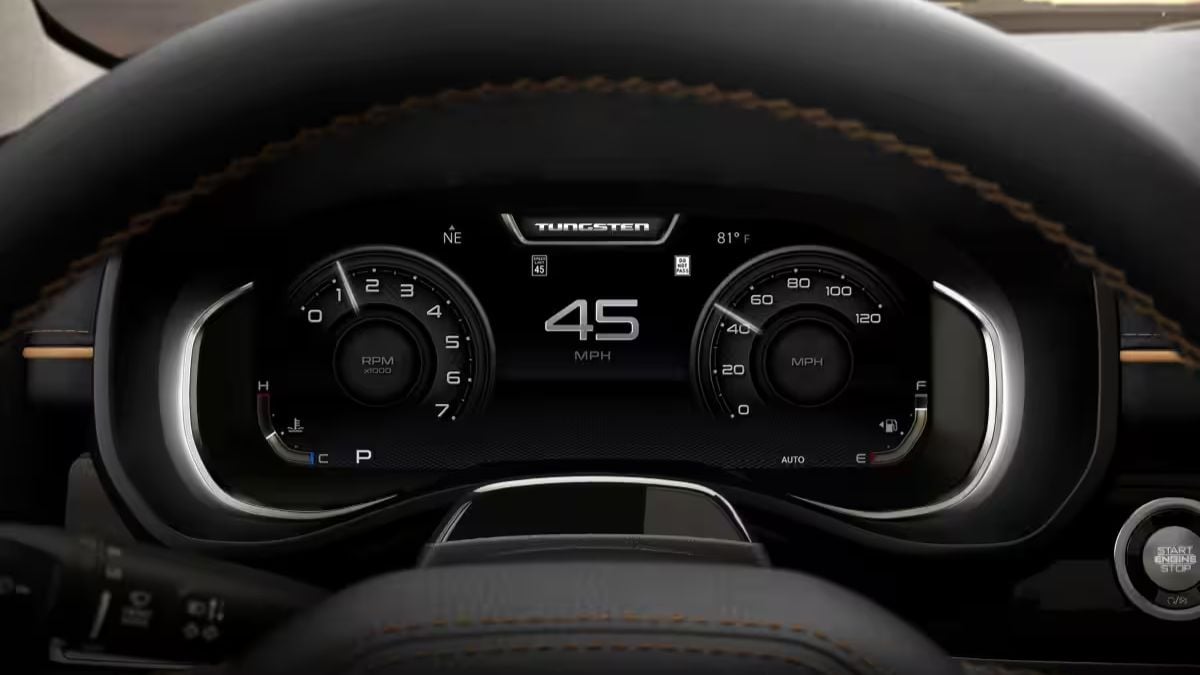 Digital instrument cluster of a 2026 Ram 1500 showing a modern display with tachometer and speedometer gauges, currently indicating 45 MPH with orange accent stitching visible on the dashboard.
