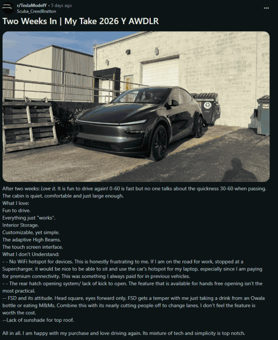 A sleek black 2026 Tesla Model Y parked near a warehouse, showcasing its modern design and innovative features.
