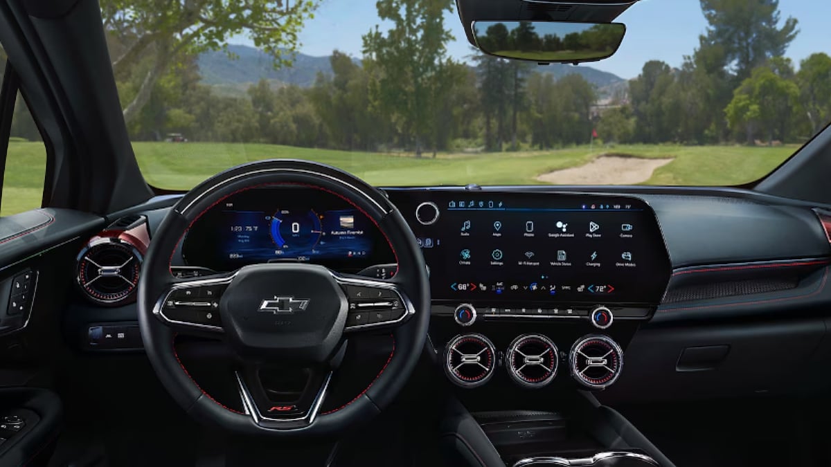 Interior view of a Chevrolet Blazer EV featuring its digital gauge cluster, large infotainment screen, and sporty dashboard design.