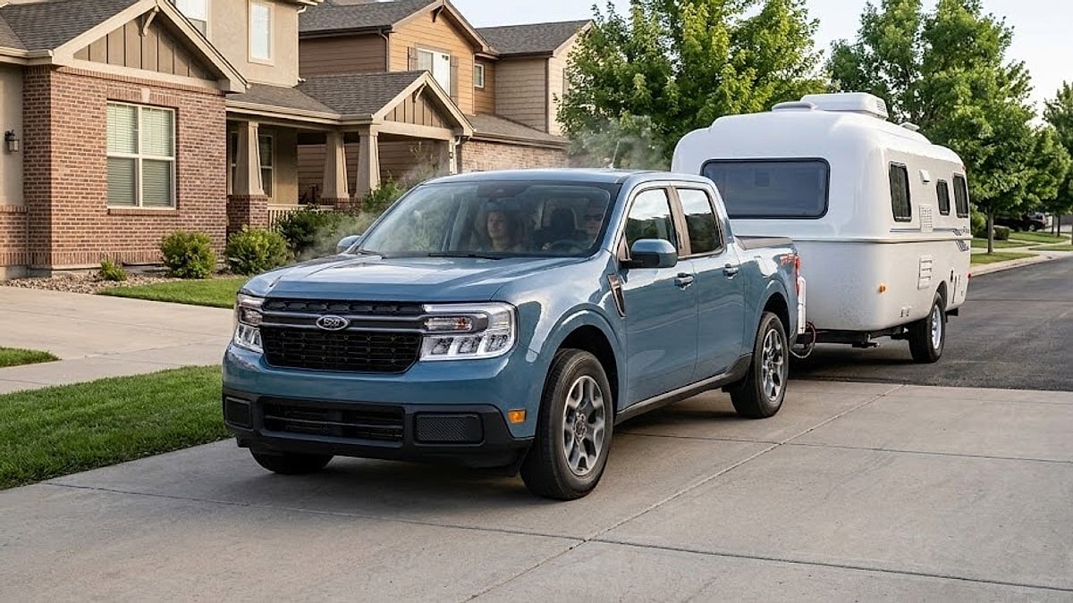 2026 Ford Maverick Hybrid towing an ATV parked neatly in front of a modern suburban neighborhood driveway