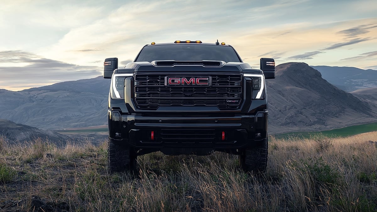 Black 2026 GMC Sierra 2500 HD AT4X shown from the front on a mountain overlook.