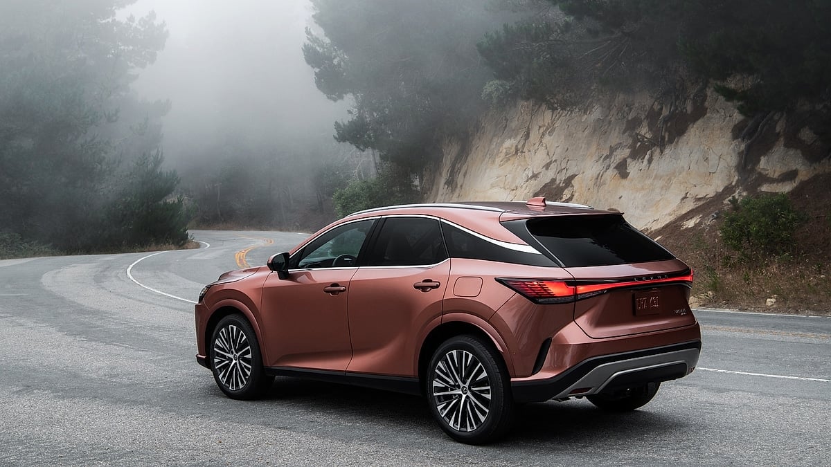 Copper 2026 Lexus RX on a foggy road, rear three-quarter view