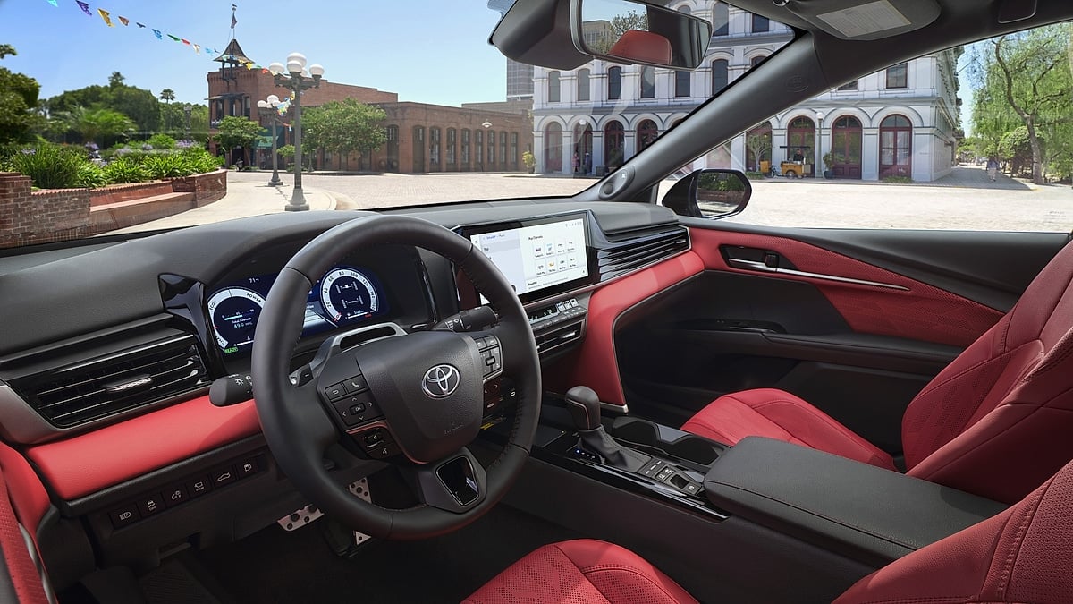 2026 Toyota Camry XSE interior with red seats, digital gauges, center touchscreen and black dashboard trim.