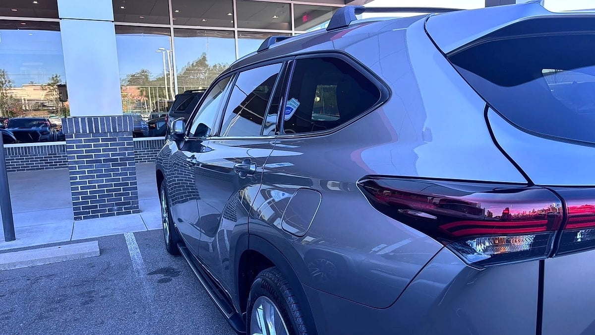 2026 Toyota Highlander parked in the dealer's pre-delivery lane waiting for license plate installation