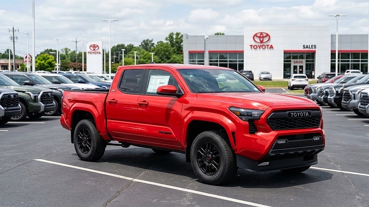 2026 Toyota Tacoma SR5 on dealer lot featuring clean Monroney window sticker, optimized for midsize truck consumer market research