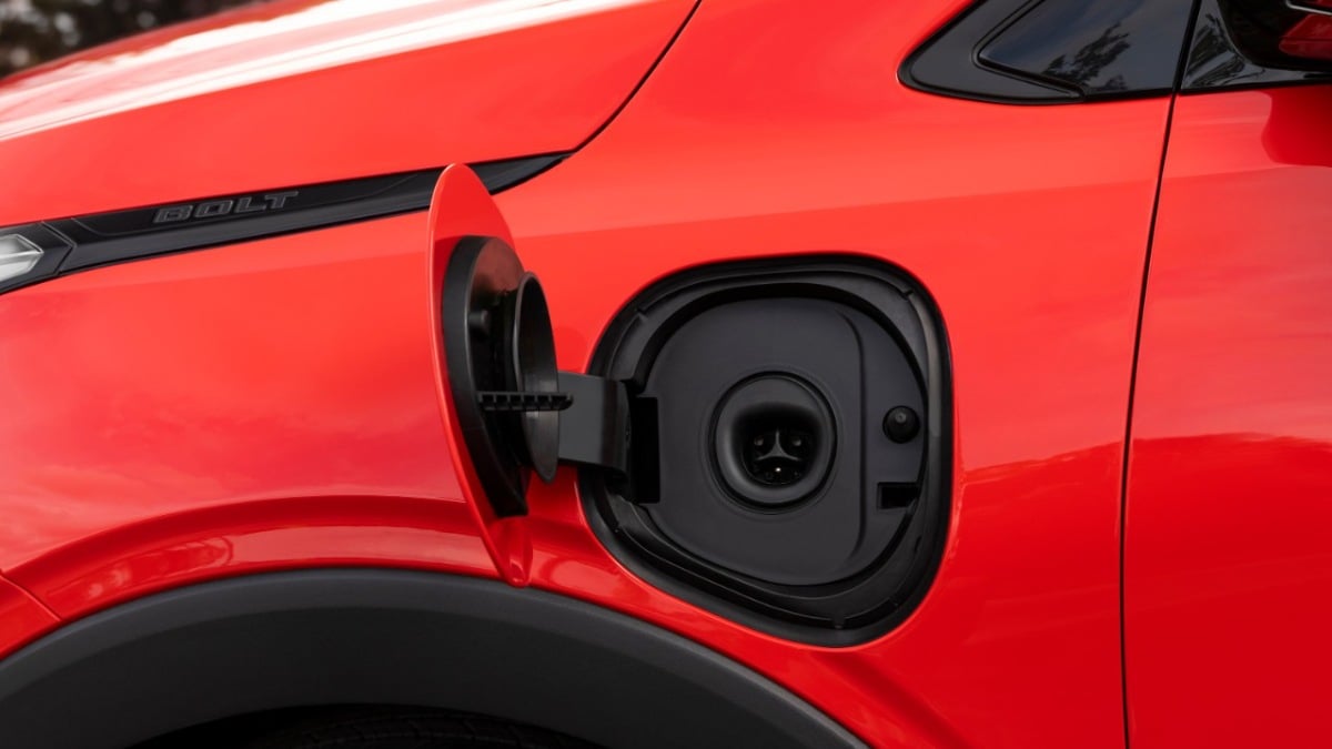 2027 Chevrolet Bolt EV red electric car charging port close-up with open charge door