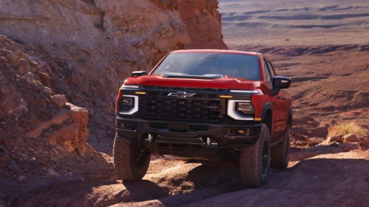 2027 Chevrolet Silverado 1500 ZR2 Bison in Apex Red shown in a desert setting.
