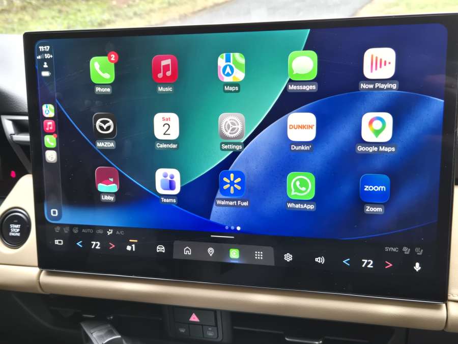 The screen of a Mazda CX-5 is shown with Apple CarPlay running. 