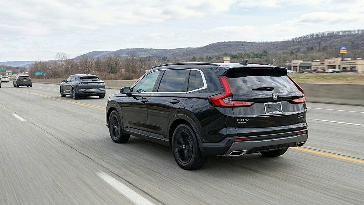 A black 2026 Honda CR-V Hybrid Sport-L, owned by Tyler Kisacky, travels down a multi-lane highway in Binghamton, New York, on a partly cloudy day