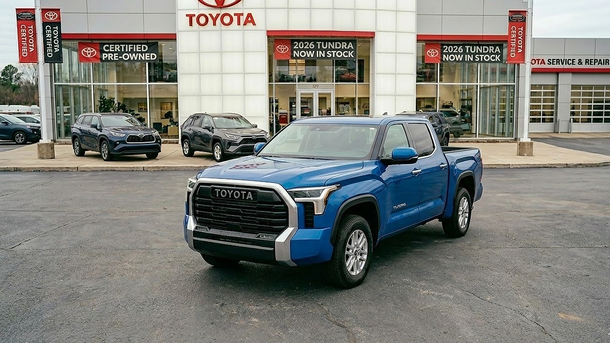 A blue 2026 Toyota Tundra sits in a clean dealership lot, showing the modern design and 'TOYOTA' grille in sunlight