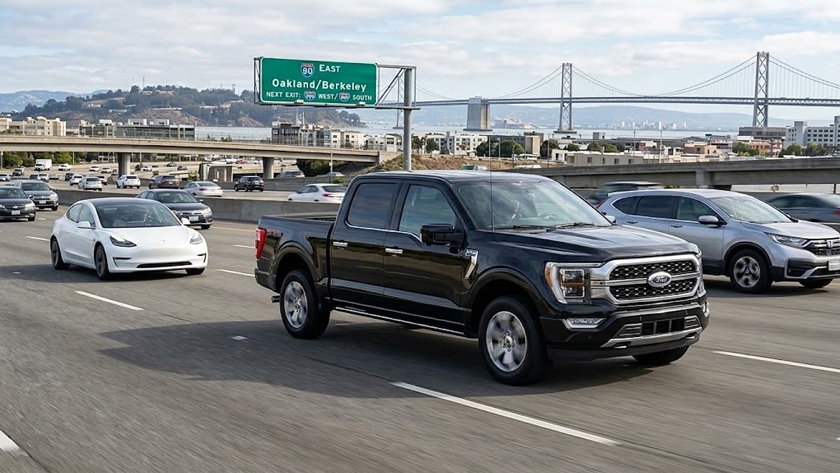 A detailed photograph captures a black 2026 Ford F-150 Lariat SuperCrew driving eastbound on I-80 in Oakland, California