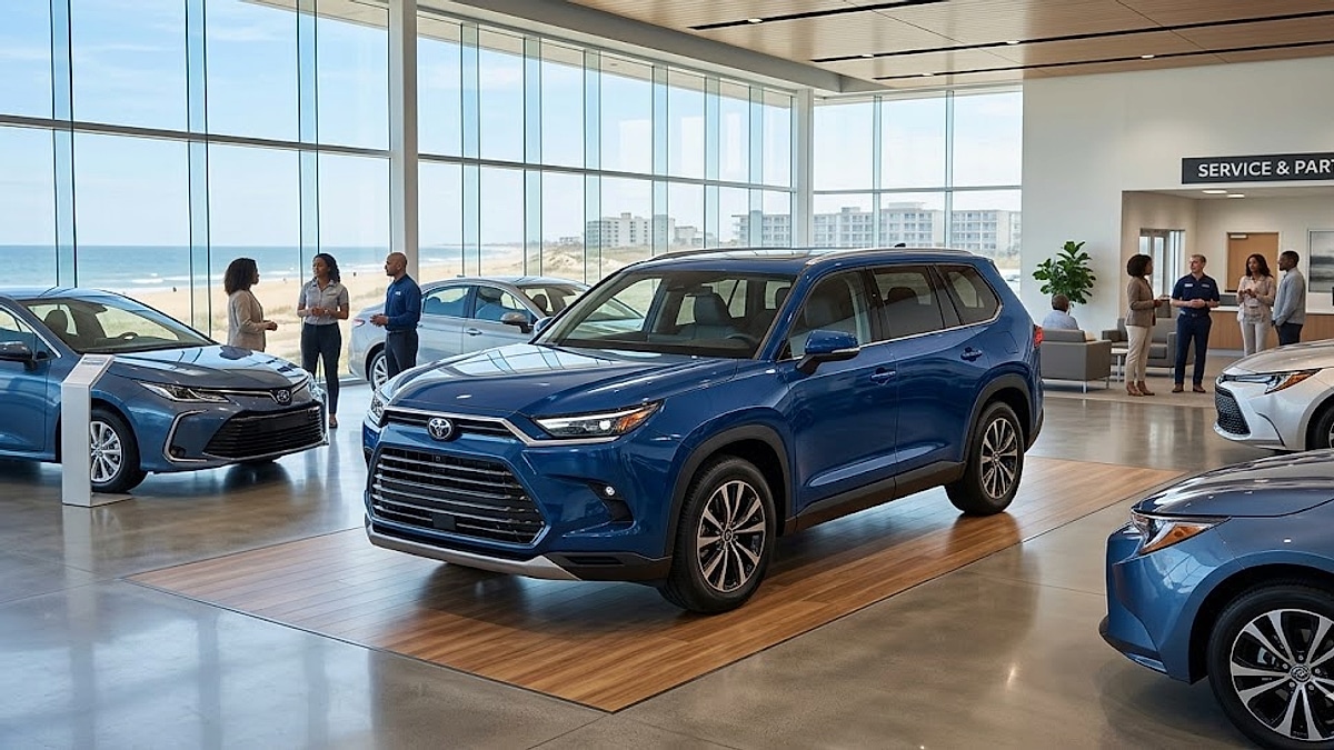 A gleaming, blueprint blue 2026 Toyota Grand Highlander Hybrid is showcased on a polished showroom floor, overlooking the Atlantic coastline in Virginia Beach