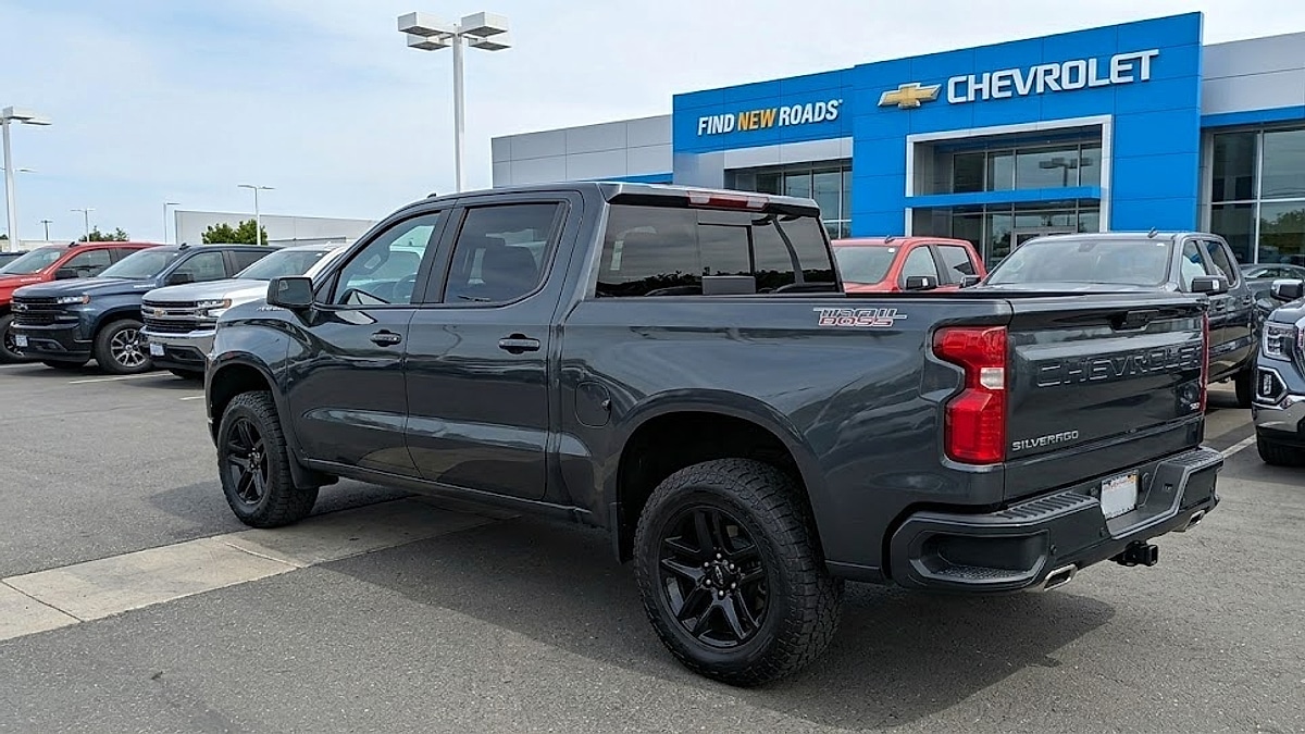 A pristine dark gray 2026 Chevrolet Silverado Trail Boss crew cab truck parked on a dealer's lot before vandalism