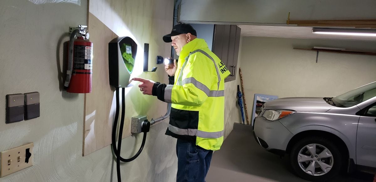An electrical inspector checks out a newly-installed EV charger