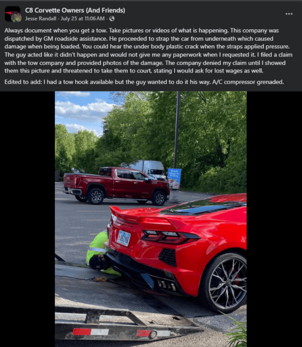 A red C8 Corvette being loaded onto a tow truck, with a worker securing it, showcasing slight damage to the car's underbelly.
