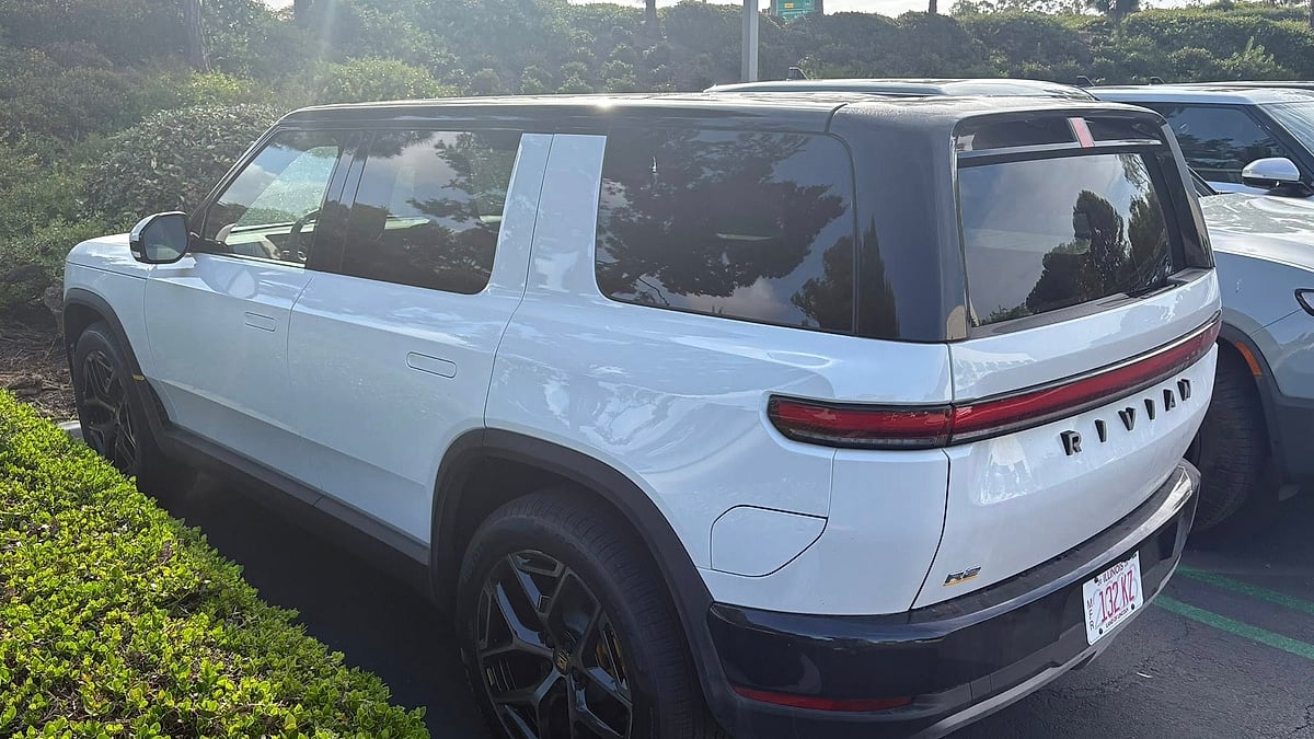 Creamy white Rivian R2 parked at Rivian's Irvine, CA HQ parking lot
