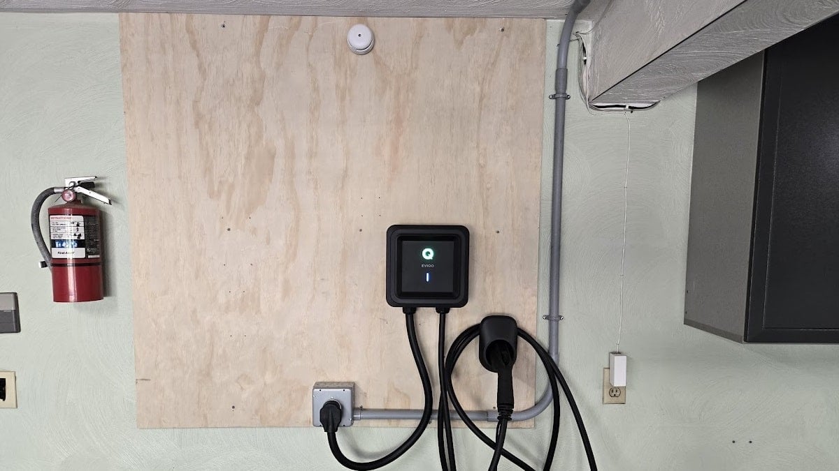 A home EV charger with smoke detector and fire extinguisher