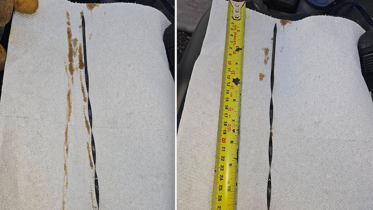 F-150 owner in Waterloo shows his 5.0L engine oil 10 inches overfull on dipstick after a dealership service package shortcut