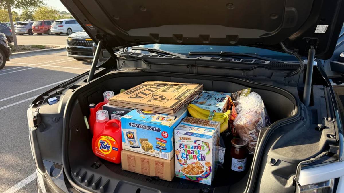 Ford F-150 Lightning frunk open and loaded with groceries, showing front trunk storage capacity