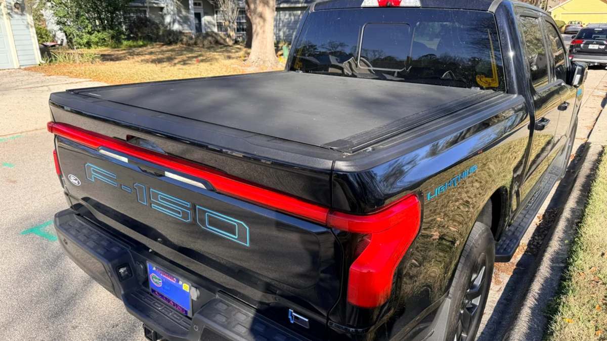 Ford F-150 Lightning rear three-quarter view with closed bed and tonneau cover installed