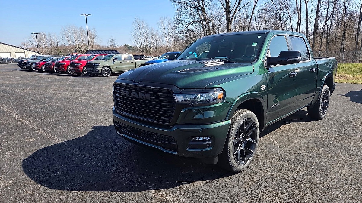Front view of a 2026 Timberline Green Ram 1500 pickup parked in the lot of the Ram dealer