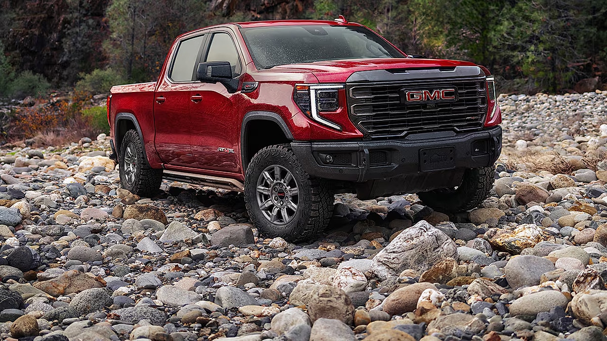 GMC Sierra 1500 AT4 pickup truck driving over rocks on an off road trail