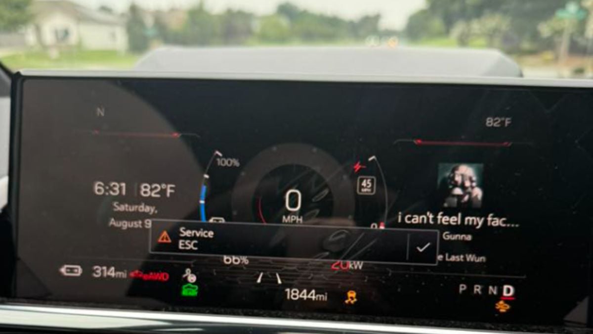 Sierra EV dashboard displaying music track, &quot;i can't feel my face&quot; by Gunna on a digital screen. Time is 6:31 with 82°F temperature. Alert shows &quot;Service ESC.&quot;