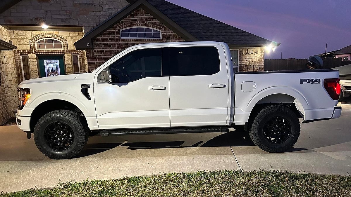 Jon Clark's white 2025 Ford F-150 parked in the driveway of his Texas home at night