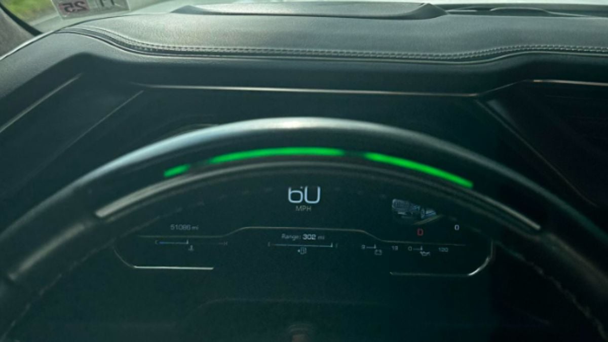 Close-up of a Ford Expedition dashboard displaying 60 MPH with a green light strip above. The screen shows a range of 302 miles and a current mileage of 5,108 miles.