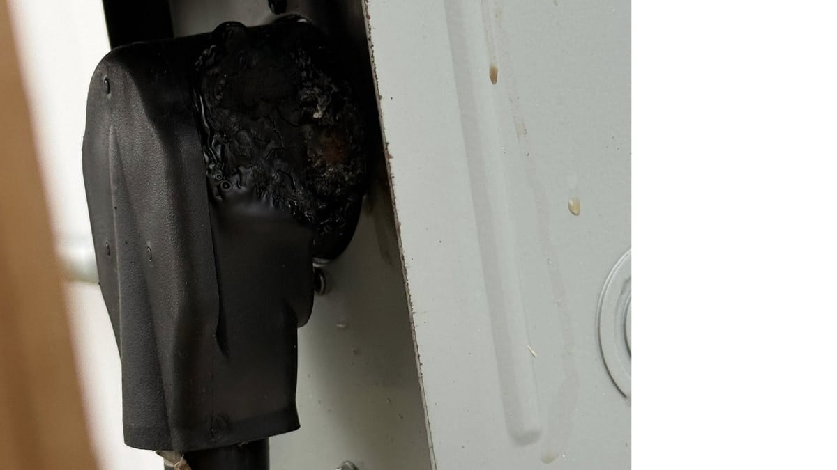 Melted EV charger wall plug in a NEMA 6-50 outlet