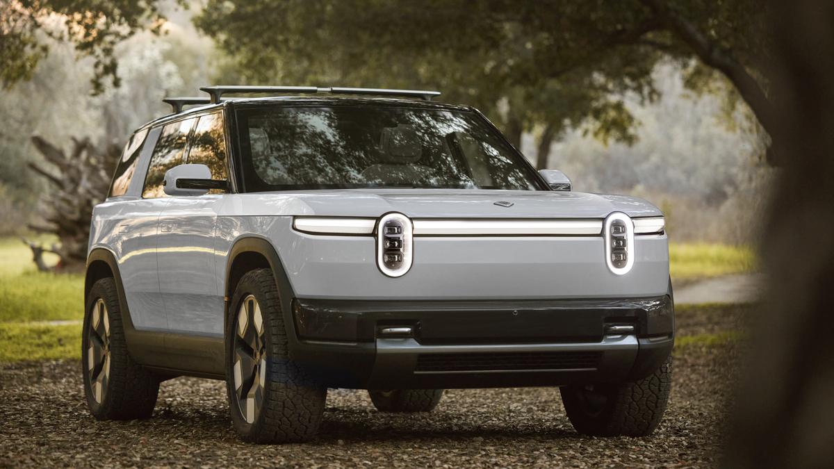 White Rivian R2 in Forrest 