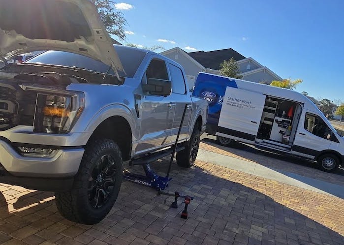 Ron Vic's Ford F-150 being serviced in the driveway 
