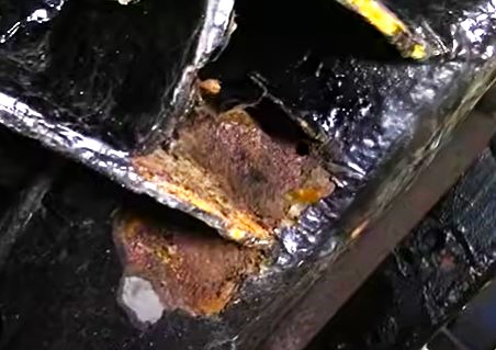 Car Frame Showing Rubberized Coating Peeling and Heavy Rusting