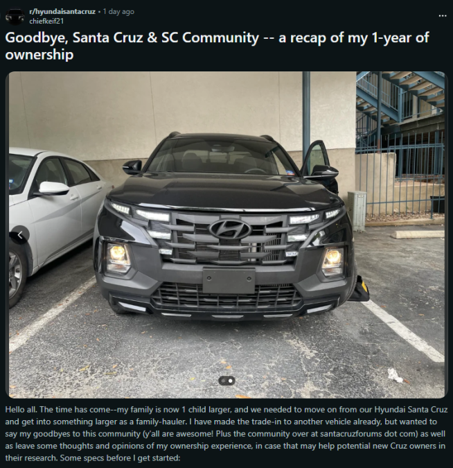 A black Hyundai Santa Cruz parked with the driver's door open, showcasing the vehicle as the owner prepares to say goodbye after one year.
