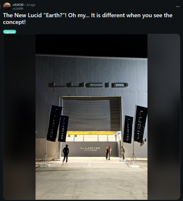 The entrance to a Lucid Motors event showcases large banners and two figures discussing the new Lucid "Earth" concept.