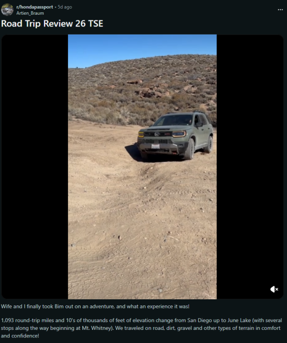 A Honda Passport parked on a rugged dirt road surrounded by rocky hills under a clear blue sky, showcasing an adventurous road trip setting.