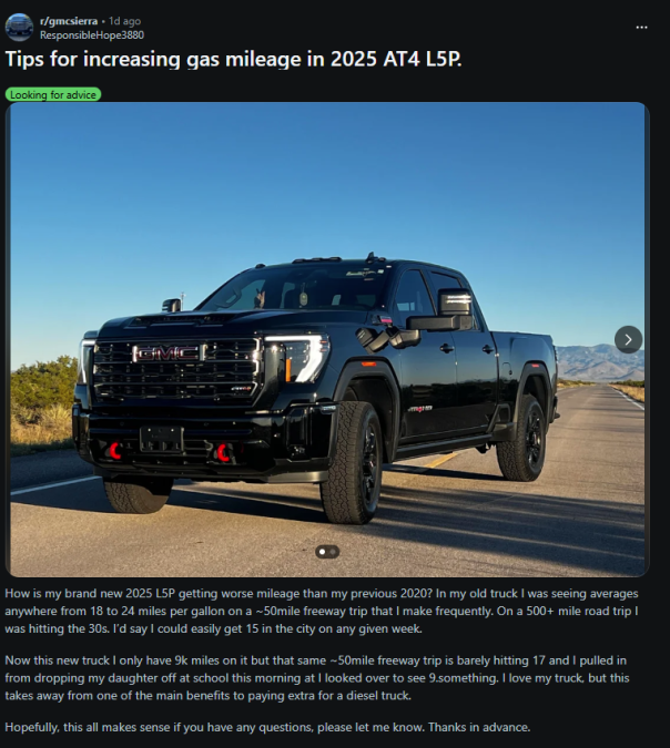 A black 2025 GMC Sierra AT4 L5P parked on an open road with mountains in the background, showcasing the truck's bold design.