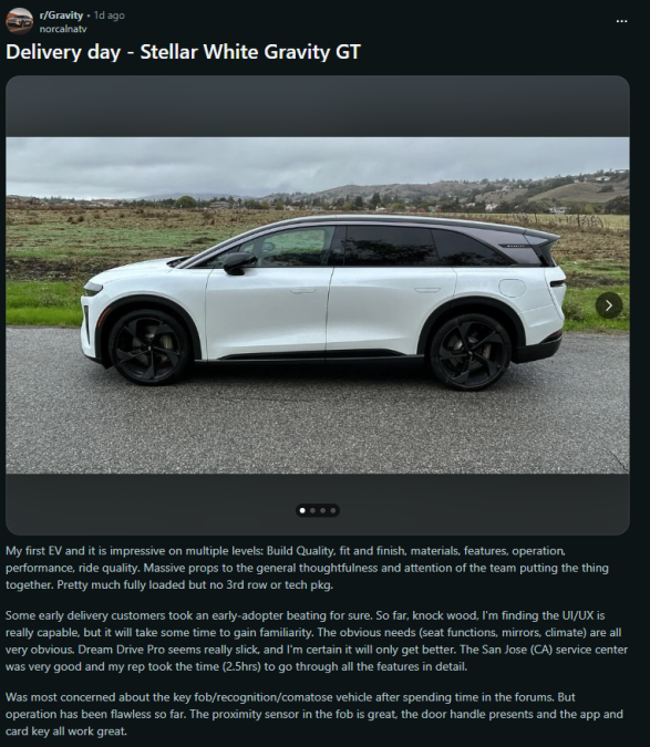 A Stellar White Gravity GT electric vehicle parked on a wet road, surrounded by green hills under a cloudy sky, showcasing its sleek design.