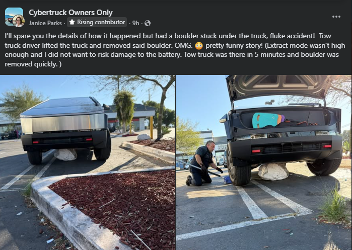 Silver Tesla Cybertruck parked on a curb with a large round boulder wedged underneath the center of the truck. A tow truck operator is seen kneeling beside the vehicle in a parking lot, preparing to remove the rock. Landscaping mulch, pavement markings, and palm trees are visible in the background.
