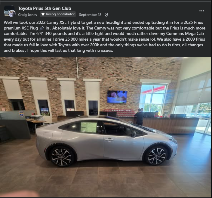 Silver 2025 Toyota Prius displayed inside a dealership showroom, side profile view showing alloy wheels and sleek hybrid design.