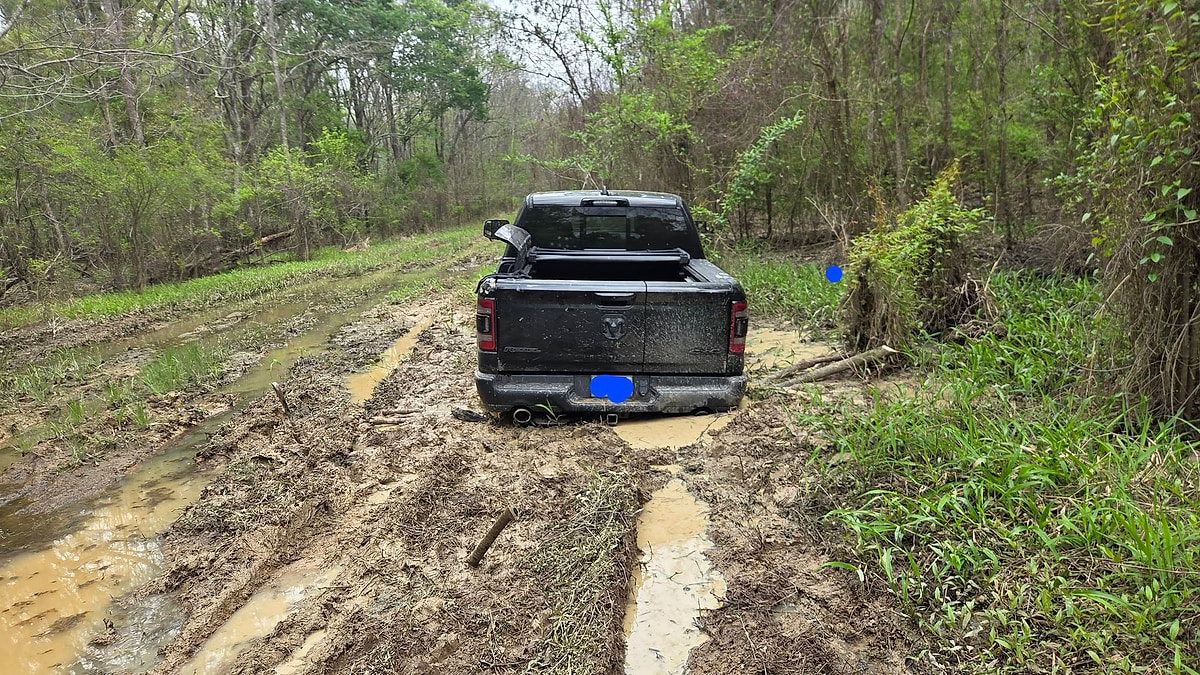 Steven Hughes' 2025 Ram Rebel rear view of the truck stuck deep in the Georgia mud